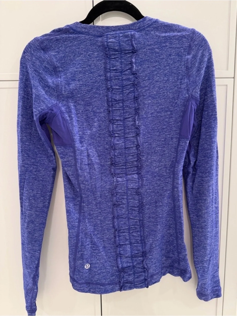 lululemon heathered Blue size 6 long sleeve top. Ruffle down back. Thumb holes